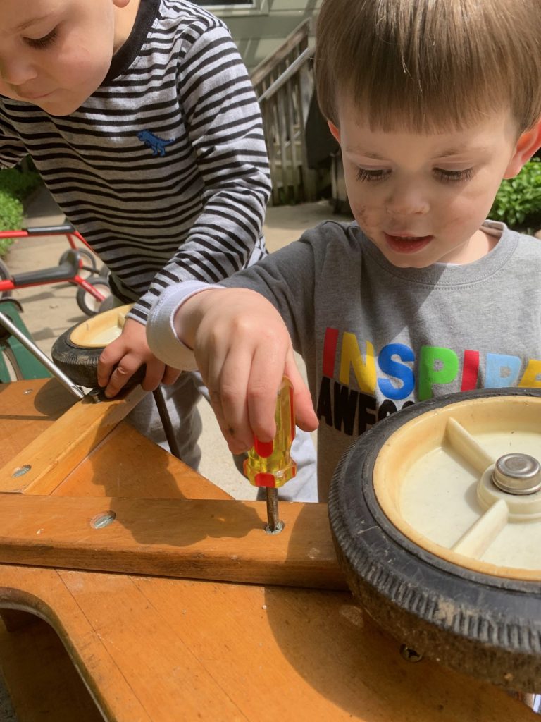 kids using tools on a wagon